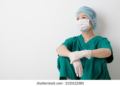 Positive Young Asian Surgeon Resting After Successful Surgery