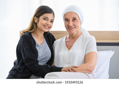 Positive Young Asian Woman Supporting Mature Foster Mother With Cancer During Rehabilitation Process In Hospital