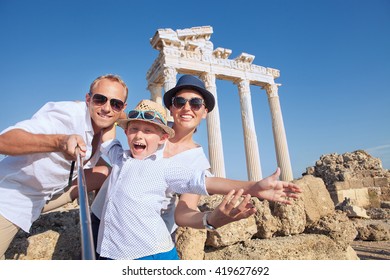 Positive Young Family Take A Selfie Photo Near Antique Temple Of Apollo,Side,Turkey