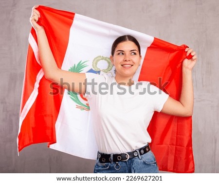 Positive young girl with Peru flag rooting for your favorite team