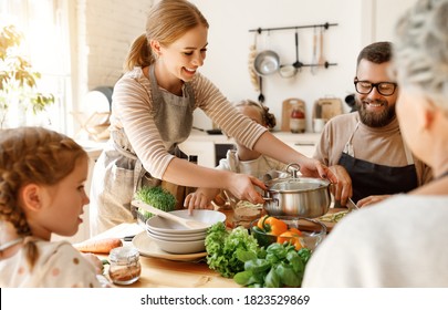 Positive young housewife with little daughters, husband and grandmother gathering around kitchen table and preparing delicious healthy dishes with fresh ingredients for family lunch at home
 - Powered by Shutterstock