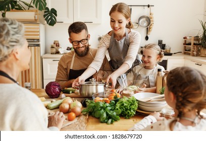 Positive young housewife with little daughters, husband and grandmother gathering around kitchen table and preparing delicious healthy dishes with fresh ingredients for family lunch at home
 - Powered by Shutterstock