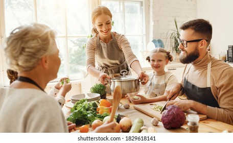 Positive young housewife with little daughters, husband and grandmother gathering around kitchen table and preparing delicious healthy dishes with fresh ingredients for family lunch at home
 - Powered by Shutterstock