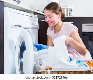 Positive Young Woman 25-30 Years Old Doing Laundry At Home  