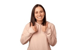 Positive Young Woman Says You Did A Good Job While Holding Two Thumb Up. Studio Shot Over White Background.