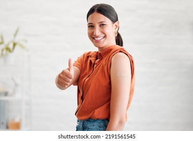 Positive Young Woman Treated With Covid Vaccine Injection, Gestures Thumbs Up And Showing Her Arm To Approve Immunization. Happy Healthy Female Patient Wearing Bandaid After Her Treatment Shot