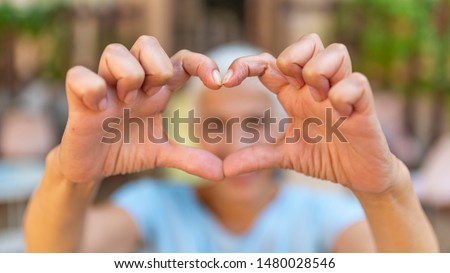 Positivity. Happy Funny Senior Woman Showing Symbol of Heart. Cute senior old woman making a heart shape with her hands and fingers. Perfect, nice, aged, old, pretty woman