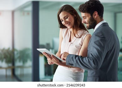 Positivity inspires productivity. Shot of a young businessman and businesswoman using a digital tablet together in an office. - Powered by Shutterstock