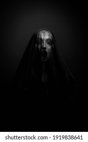 Possessed Woman screaming with her face covered - Shutterstock ID 1919838641