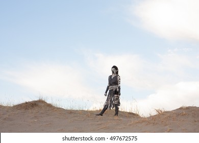 Post Apocalyptic Humanoid On A Desolate Dry Desert Sand Dune Looking Out Over A Vast Wasteland 