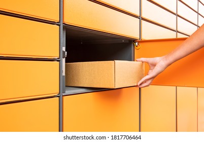 Post automat terminal and hand with parcel - Shutterstock ID 1817706464