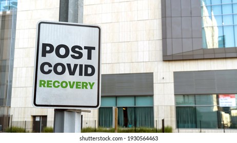 Post Covid Recover Sign In A Downtown City Setting
