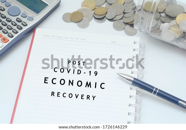 Post\
covid-19 economic recovery conceptual. Top view of an image with\
\'POST COVID-19 ECONOMIC RECOVERY\