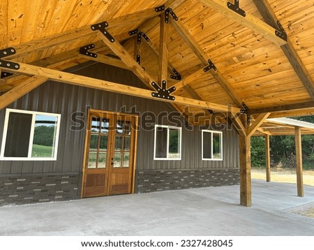 Post frame building pole barn with metal siding and metal roofing, concrete floor