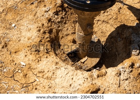 A post hole digger in the dirt