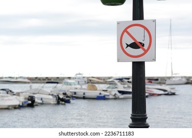 Post with No fishing sign near sea. Space for text - Shutterstock ID 2236711183