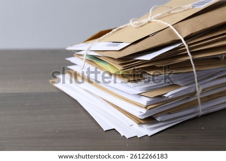 Post office. Stack of different paper envelopes on wooden table, closeup. Space for text