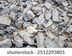 Post renovation debris. Concrete, brick, and gypsum fragments. Dirty dusty texture. Broken materials and construction waste texture. Extensive building work. Cracked bricks. Dusty trash background.