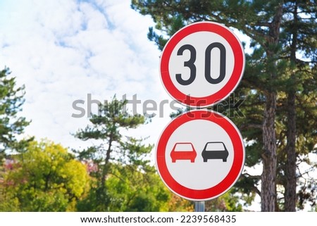 Post with road signs Maximum Speed 30 and No Overtaking outdoors. Space for text