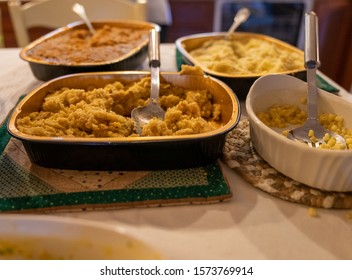 Post Thanksgiving Dinner Carnage. Leftover Food From Big Holiday Dinner In Serving Dishes.