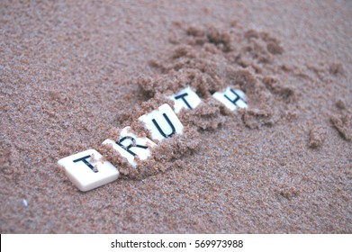 Post Truth: Letters spelling 'truth' becoming buried in sand