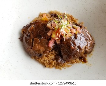 Posta negra or Colombian style black beef. Traditional cusine plate from Cartagena Colombia with coconut rice.  - Shutterstock ID 1272493615