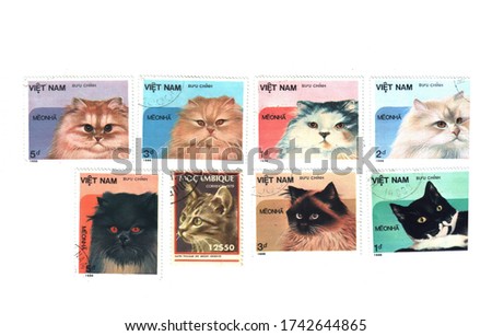 Postage stamps with the image of cats in 1986, laid out on a white background. Stamps can be redeemed, different categories and prices, different countries of Mozambique and Vietnam. The concept of ph