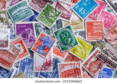 Postage stamps.A collection of world stamps in a pile.Postage stamps from different countries and times