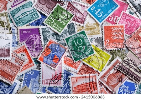 Postage stamps.A collection of world stamps in a pile.Postage stamps from different countries and times