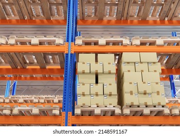 Postal logistics center. Postal boxes are stored on racks. Logistic center with parcels. Shelving with flights in postal warehouse. Close-up stacked shelving. Cardboard boxes with stickers. 