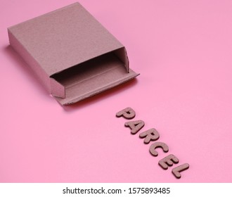 Postal services minimal concept. Empty cardboard box on pink paper background with a slogan parcel