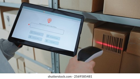 Postal Warehouse Associate Scans QR Code on Cardboard Box with Barcode Scanner, Checks Parcel Information. Tablet Computer Screen Shows Delivery Tracking App to Monitor Package Routing. Close Up.