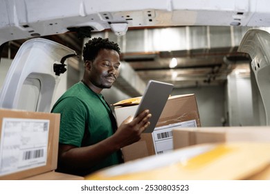 Postal worker checking packages and loading the van.