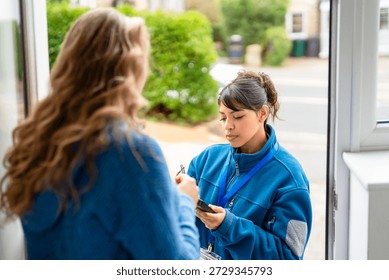 Postal worker talks to a resident while delivering mail in a neighborhood