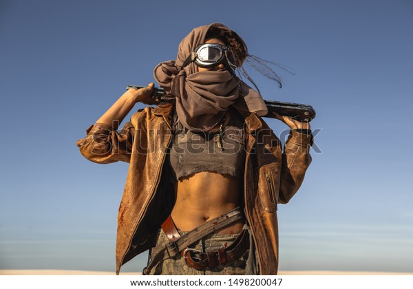 Post-apocalyptic woman with weapon outdoors.\
Young slim girl warrior in shabby clothes holding sword standing in\
a confident pose looking away. Nuclear post-apocalypse time. Life\
after doomsday