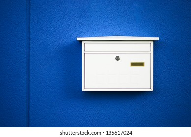 Postbox white on a blue wall ,outdoor