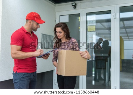 Postboy doing his job and delivering the items to his customer.