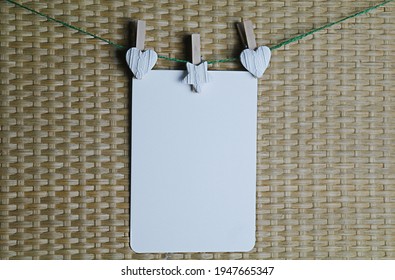 Postcard Hangs On Clothespins On A String, For Mockup