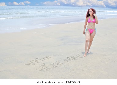 Postcard Image Of Woman Writing Wish You Were Here In The Sand