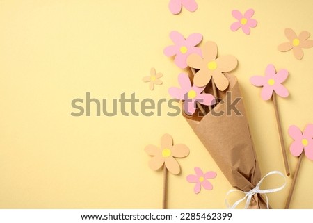 Postcard layout for Mother's Day. Children's crafts bouquet of flowers made of colored cardboard.