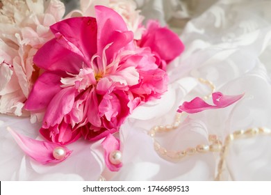 postcard mockup. flower composition. pink peonies on a white background, jewelry, pearls and space for text. congratulation. invitation. flat lay