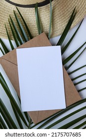 Postcard Mockup. Summer Holiday Concept. Romantic Composition Of Straw Hat, Palm Leaf And Sea Shells On White Background