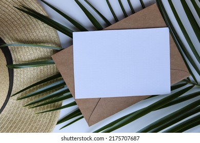 Postcard Mockup. Summer Holiday Concept. Romantic Composition Of Straw Hat, Palm Leaf And Sea Shells On White Background