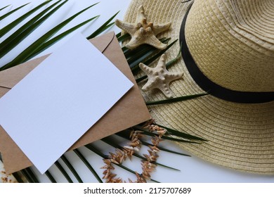 Postcard Mockup. Summer Holiday Concept. Romantic Composition Of Straw Hat, Palm Leaf And Sea Shells On White Background