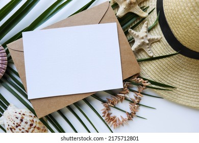 Postcard Mockup. Summer Holiday Concept. Romantic Composition Of Straw Hat, Palm Leaf And Sea Shells On White Background. Invitation