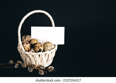 Postcard, White Straw Basket Full Of Quail Eggs, Pussy Willow Branch On Black Background. Copy Space. Empty Text Place. Mockup Design Of Easter Holiday. Handmade Decor. Healthy Food. Visiting Card.