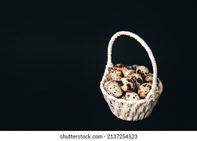 Postcard, White Straw Basket Full Of Quail Eggs On Black Background. Copy Space. Empty Text Place. Mockup Design Of Easter Holiday. Handmade Decor. Healthy Food. Visiting Card.