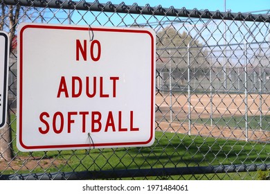 Posted Red And White Sign At A Youth Sports Complex. No Adult Softball. Men's, Women's And Coed Softball Leagues Promote Fitness And Community Through This Active Team Sport.                      