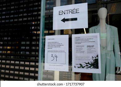 A Poster Advising Customers To Practise Social Distancing While Shopping At Entrance Of  Retail Shop During Covid-19 Outbreak In Brussels, Belgium, On April 29, 2020