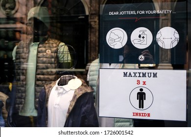 A Poster Advising Customers To Practise Social Distancing While Shopping At Entrance Of  Retail Shop During Covid-19 Outbreak In Brussels, Belgium, On May 8, 2020